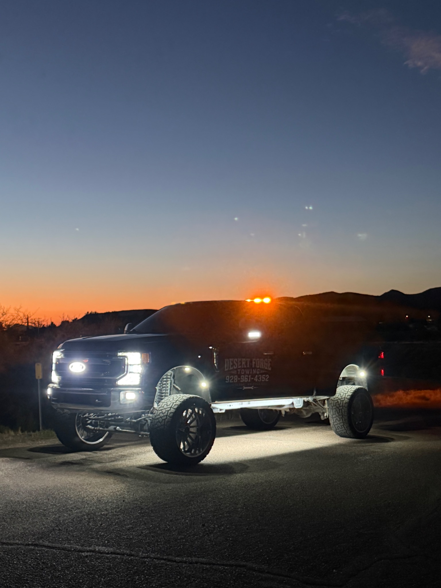 Desert Forge Towing truck towing a Ram pickup on a trailer
